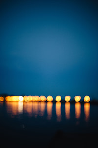 City lights reflected in the water at night thumbnail