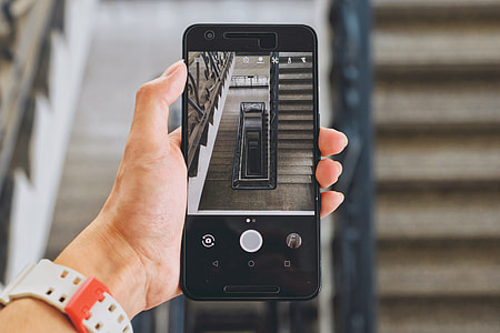 person taking photo using black smartphone thumbnail