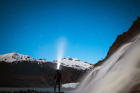 person holding lighted flashlight thumbnail