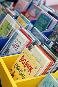 assorted books in multicolored wooden shelves thumbnail