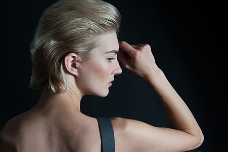 photograph of back view of woman in black strap shirt thumbnail