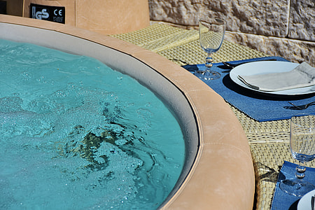 round white plate and clear long-stemmed wine glass beside above ground pool thumbnail