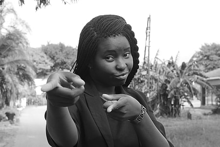 women in black blazer pointing finger thumbnail