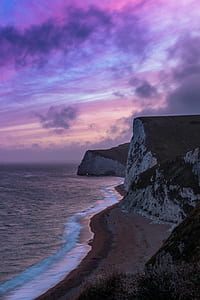 cliff near ocean during golden hour thumbnail