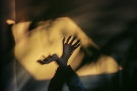 person's hands raising thumbnail