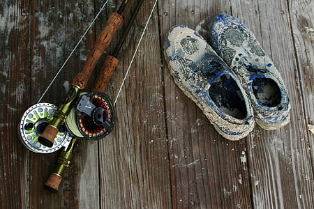 brown fishing rod beside blue low-top sneakers thumbnail