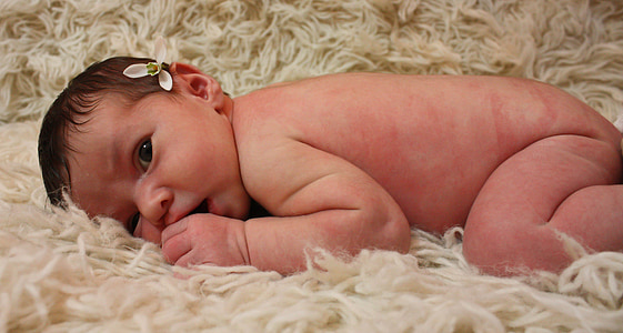 baby lying on beige fur textile thumbnail