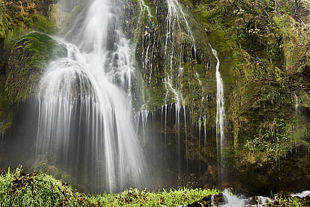 waterfalls in rocky mountains during daytime thumbnail