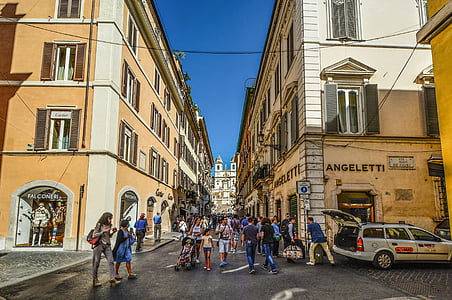 people walking on street in the middle of Angeletti building thumbnail