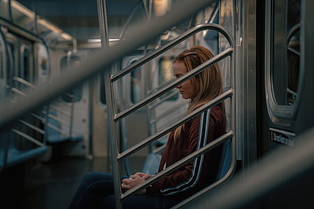 woman sitting on subway train seat thumbnail