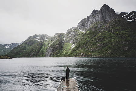 man in dock facing lake thumbnail