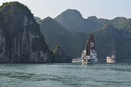 three white power boats on calm body of water thumbnail