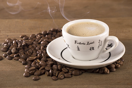 coffee beans and white ceramic cup and saucer thumbnail