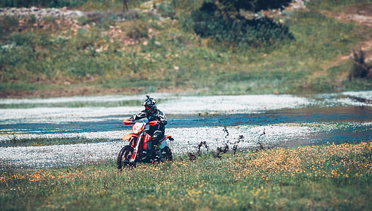 man riding a red motorcycle thumbnail