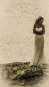 woman standing on stone near sea thumbnail