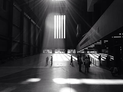 silhouette of people walking inside concrete building at daytime thumbnail