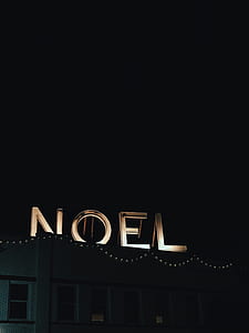 photo of noel signage at night time thumbnail
