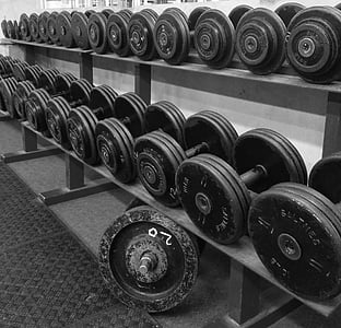 black dumbbells on rack thumbnail