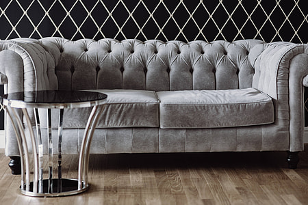 Elegant grey sofa with a laptop, an iPhone and a magazine thumbnail