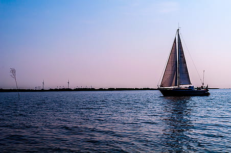 brown sail boat on sea thumbnail