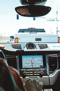 person driving vehicle with navigation system during daytime thumbnail