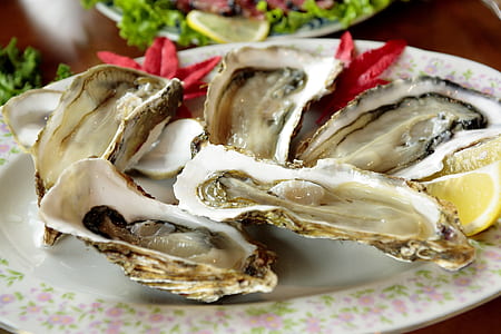 oysters in round white and pink floral ceramic plate thumbnail