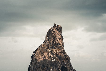 brown boulder under gray clouds thumbnail