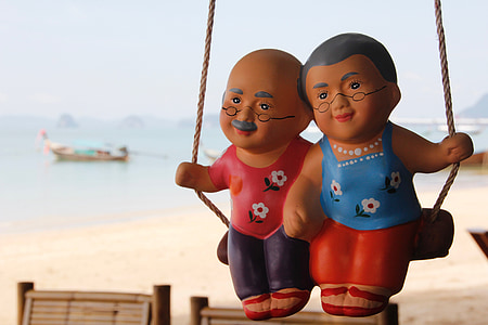 closeup photo of woman and man swing toy thumbnail