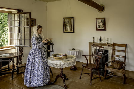 woman standing in front of pedestal table thumbnail
