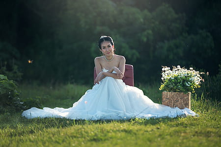 woman in white wedding dress sitting on seat thumbnail