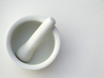 white ceramic mortar and pestle on white surface thumbnail