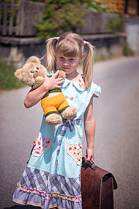 girl holding bear plush toy and handbag thumbnail