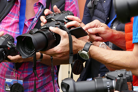 men holding DSLR cameras thumbnail