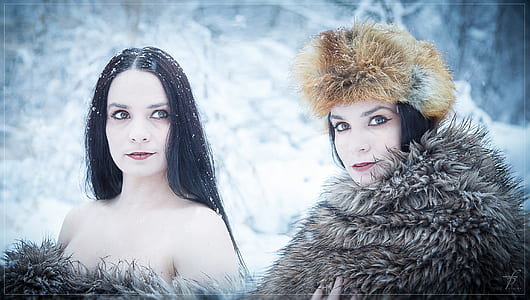 two woman taking picture on snow thumbnail