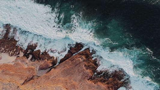 body of water beside of brown cliff thumbnail