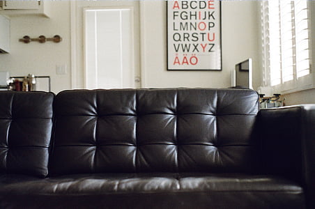 tufted black leather soda inside house thumbnail