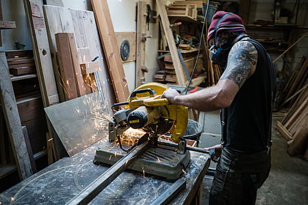 man in black tank top using DEWALT miter saw thumbnail
