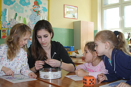 woman teaching children inside classroom thumbnail