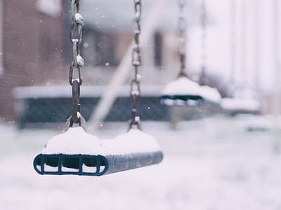 shallow focus photography of silver snow-covered utdoor swing thumbnail