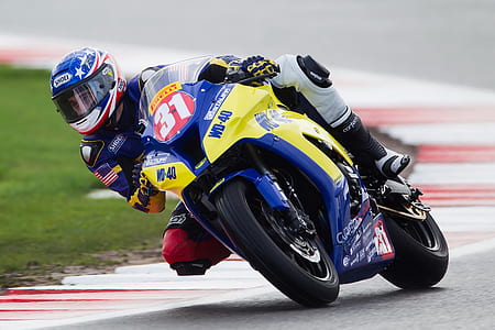 man ride on sports bike while racing circuit during daytime thumbnail