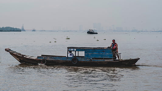 Photo of Man on Wooden Boat thumbnail