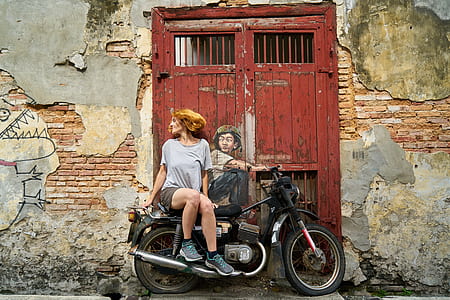 woman wearing grey top riding on black motorcycle thumbnail