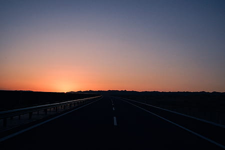 asphalt road during sunset thumbnail