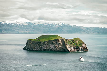white cruiser ship toward green island thumbnail