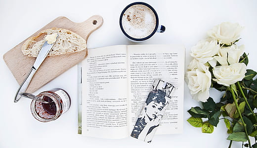 white rose flowers beside open book thumbnail