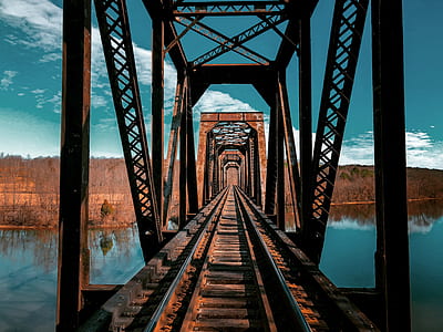 brown metal bridge below body of water thumbnail