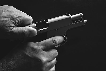 person holding semi-automatic pistol thumbnail