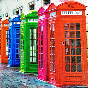 five assorted-color telephone booths near brown building thumbnail
