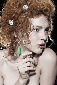 woman with blonde hair against black background thumbnail