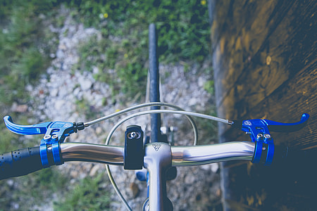 gray and blue bike near brown fence at daytime thumbnail